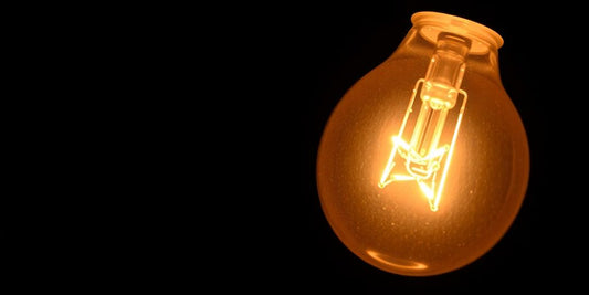 Close-up of a glowing halogen bulb on dark background.