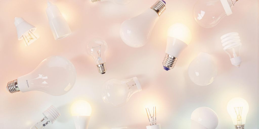 Assorted light bulbs glowing on a soft background.