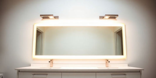 Illuminated bathroom mirror with stylish light fixtures.