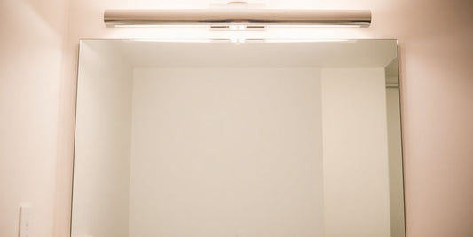 Modern bathroom vanity light above a mirror.