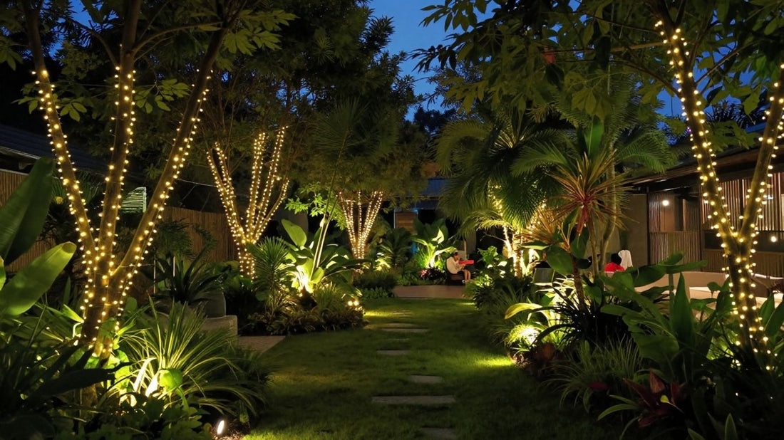 Garden illuminated by various outdoor lights at dusk.